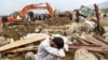 A villager reacts next to his destroyed house as rescuers search for bodies after a flash flood affected the area at Sayrah-e-Hopiyan in Charikar, Parwan province, on Aug. 26, 2020.
