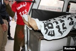 Ambulance workers load the body of Mashal Khan into an ambulance after a mob beat him to death at his university campus in Mardan, Pakistan, April 13, 2017.