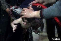 FILE - A child is treated in a hospital in Douma, near Damascus, Syria, after a suspected chemical attack, April 7, 2018.