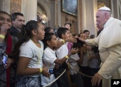 Pope Francis blesses faithful during his visit to the Morelia Cathedral in Mexico's Michoacan state, Feb. 16, 2016.