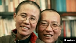 FILE - Chinese dissident Liu Xiaobo and wife Liu Xia pose in this undated photo released by his family on Oct. 3, 2010.