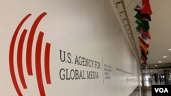 FILE - The U.S. Agency for Global Media logo is seen in the lobby of the Voice of America building, in Washington, Nov. 22, 2019. 