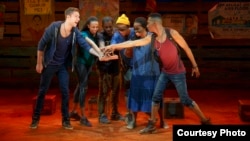 In "Invisible Thread," Griffin Matthews, right, makes a pact with the Ugandan teens and his boyfriend, at far left, who has come to meet him in Africa. (Credit: Joan Marcus)