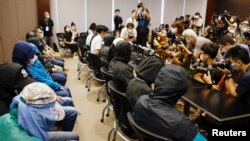 FILE - Family members of twelve Hong Kong activists, detained as they reportedly sailed to Taiwan for political asylum, hold a news conference to seek help in Hong Kong, Sept. 12, 2020.