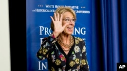 U.S. Education Secretary Betsy DeVos waves as she steps away from the podium after speaking at the White House, in Washington, Sept. 18, 2017.