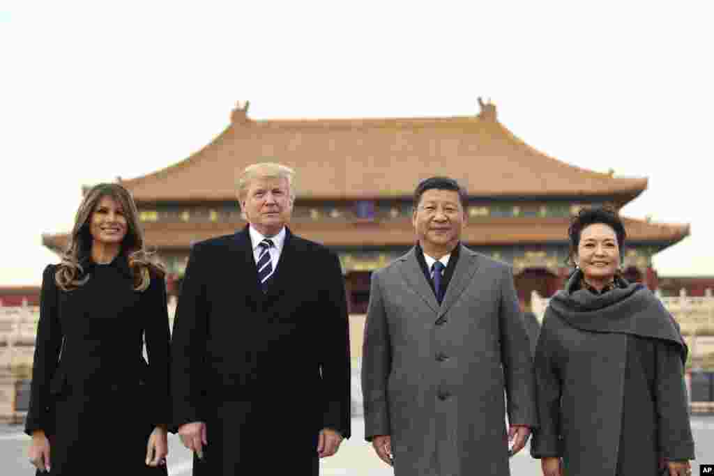 President Donald Trump, second left, first lady Melania Trump, left, Chinese President Xi Jinping, second right, and his wife Peng Liyuan, stand together as they tour the Forbidden City in Beijing, Nov. 8, 2017.