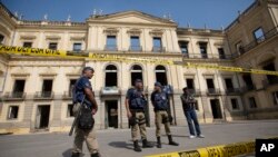 Municipality police guard the National Museum which burned the previous night in Rio de Janeiro, Sept. 3, 2018. 