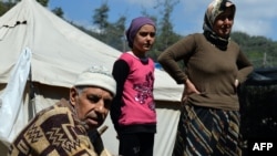 FILE - Syrian Turkmen are seen at a make-shift refugee camp some kilometers away from the Syria-Turkey border, Apr. 23, 2013. 