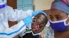 Medical workers from the Ministry of Health wearing protective suits conduct mass-testing of residents in the Eastleigh area of Nairobi, Kenya, May 20, 2020. 