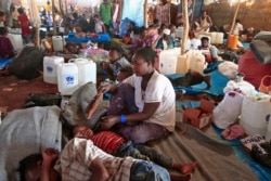 Ethiopian refugees who fled fighting in Tigray province lie in a hut at the Um Rakuba camp in Sudan's eastern Gedaref province, Nov. 18, 2020.