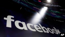 The logo for Facebook appears on screens at the Nasdaq Market Site in New York's Times Square, March 29, 2018. 
