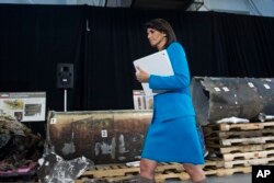 FILE - U.S. Ambassador to the U.N. Nikki Haley walks in front recovered segments of an Iranian rocket during a press briefing at Joint Base Anacostia-Bolling, Dec. 14, 2017, in Washington.