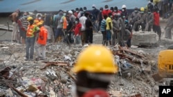 Des secouristes recherchent des survivants après l'effondrement d'un immeuble à Lagos, Nigeria, le 16 septembre 2014.