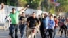 Supporter of ousted Egyptian President Mohamed Morsi is beaten by pro-government and army supporters during clashes that erupted at Tahrir Square and near the U.S. Embassy in Cairo, July 22, 2013.