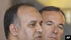 Italian foreign minister Franco Frattini , right, and vice-chairman of the Executive Board of the Libyan National Transitional Congress Ali al-Issawi talk to the media during a press conference in Rome, July 22, 2011