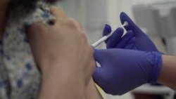 Screen grab taken from video issued by Britain's Oxford University, showing a person being injected as part of the first human trials in the UK to test a potential coronavirus vaccine, untaken by Oxford University in England, Thursday April 23, 2020…