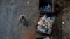 FILE - A homeless man walks next to trash bins in Beirut, Lebanon, July 12, 2020. 