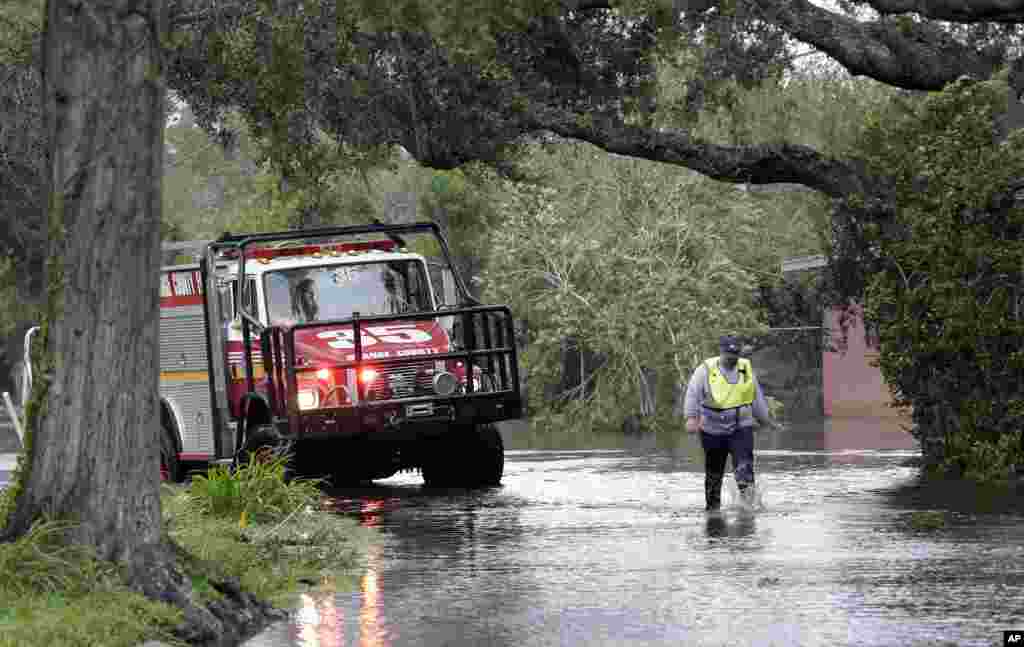Workers from Orange County rescue make a final check of an area on a flooded street after they were called to rescue residents from their homes during by Hurricane Irma, Sept. 11, 2017, in Lake Buena Vista, Florida.