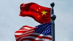 FILE - Chinese and U.S. flags flutter near The Bund before U.S. trade delegation meets its Chinese counterparts for talks in Shanghai, China, July 30, 2019.
