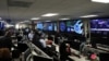FILE - U.S. Department of Homeland Security election security workers monitor screens in the DHS National Cybersecurity and Communications Integration Center in Arlington, Va., Nov. 6, 2018. 