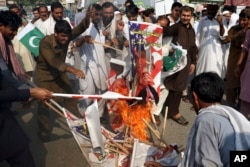 Pakistani demonstrators burn posters of U. S. President Donald Trump in Peshawar, Pakistan, Aug. 30, 2017. Protesters have objected to U.S. allegations that Islamabad is not doing enough in the war on terror.