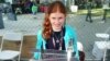 Genevieve Beatty, 11, stands in front of the Mars model robot she made with her sister Camille and her father, Robert. It was specially commissioned by the New York Hall of Science. (VOA Photo: A. Phillips) 