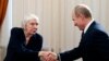 FILE - Russian President Vladimir Putin shakes hands with Lyudmila Alekeyeva, the head of the Moscow Helsinki Group, in Novo-Ogaryovo residence outside Moscow, Jan. 23, 2014. Russia's government is trying to shut the group, according to a website notice seen Dec. 20, 2022.
