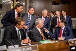Members of the Senate committee speak together before the start of a Senate Foreign Relations Committee hearing on Capitol Hill, in Washington, July 23, 2015.
