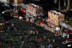 Investigators work at a festival grounds across the street from the Mandalay Bay Resort and Casino, Oct. 3, 2017, in Las Vegas.