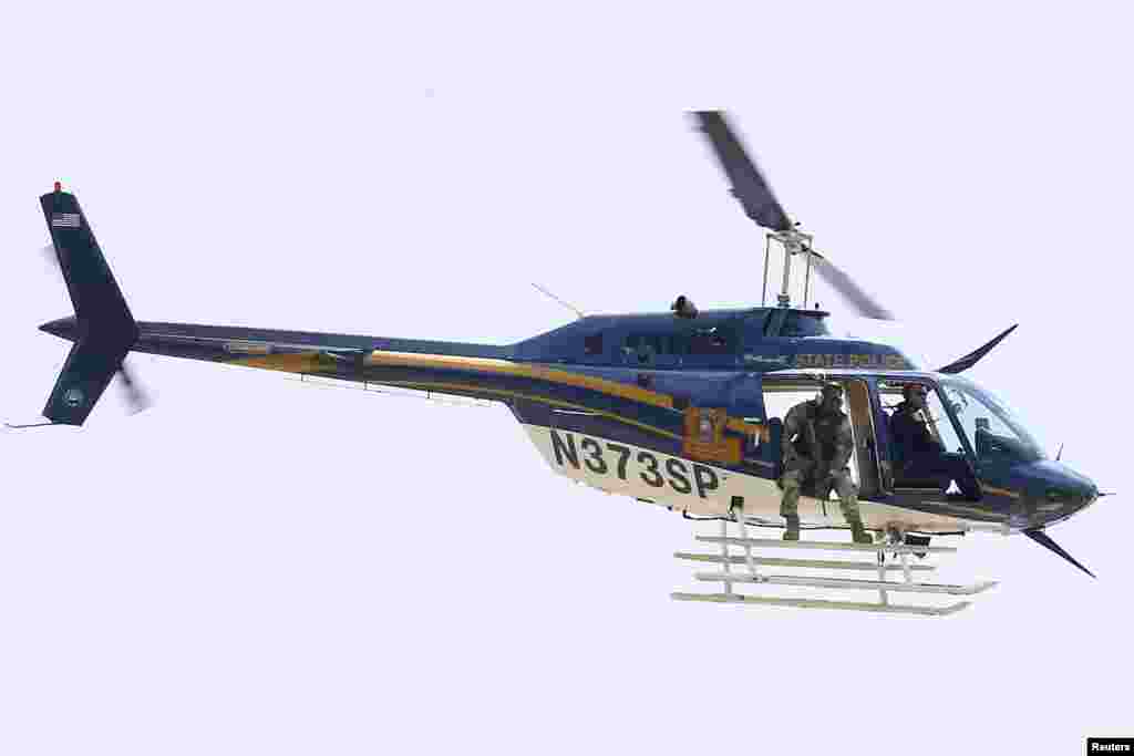 A law enforcement helicopter is seen near the scene where police officers were shot in Baton Rouge, July 17, 2016.