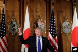 President Donald Trump speaks, accompanied by Japanese Prime Minister Shinzo Abe during a joint news conference at the Akasaka Palace, Monday, Nov. 6, 2017, in Tokyo.