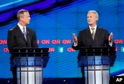 Former Maryland Gov. Martin O'Malley, left, listens as former Rhode Island Gov. Lincoln Chafee speaks during the CNN Democratic presidential debate in Las Vegas, Oct. 13, 2015.