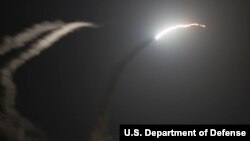The guided-missile cruiser USS Philippine Sea launches a Tomahawk cruise missile at a target in Syria, Sept 23, 2014.