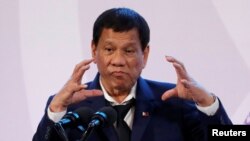 FILE - Philippines' President Rodrigo Duterte gestures during a news conference on the sidelines of the Association of South East Asian Nations summit in Pasay, metro Manila, Philippines, Nov. 14, 2017. 