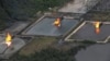 FILE - A gas flare at Shell Cawtharine Channel, Nembe Creek in the Niger Delta. 