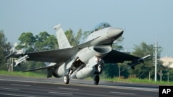 FILE - A Taiwan Air Force F-16 fighter jet lands on a closed section of highway during the annual Han Kuang military exercises in Chiayi, central Taiwan, Sept. 16, 2014. U.S. arms sales to Taiwan now reportedly total some $12 billion.