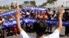 A leader, foreground, of Cambodian activists controls the group to pay respects in front of Royal Palace during a march toward the National Assembly, in Phnom Penh, file photo. 