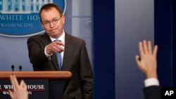FILE - Director of the Office of Management and Budget Mick Mulvaney calls on a reporter during a White House briefing in Washington, Jan. 19, 2018.