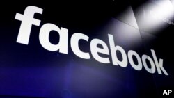 FILE - The logo for Facebook appears on screens at the Nasdaq MarketSite, in New York's Times Square.