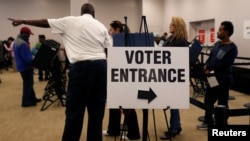 Voters wait in line to cast their ballots during early voting at the Franklin County Board of Elections in Columbus, in Columbus, Ohio, Oct. 28, 2016.
