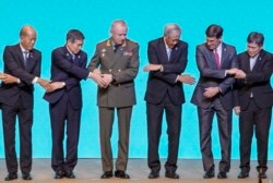 FILE - ASEAN defense ministers and Dialogue Nations defense ministers pose for a group photo during a meeting on Nov. 18, 2019, in Bangkok, Thailand.