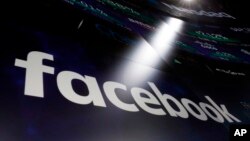 The logo for Facebook appears on screens at the Nasdaq MarketSite in New York's Times Square, March 29, 2018. 