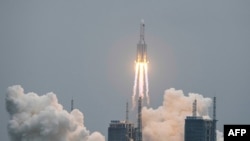 A Long March 5B rocket, carrying China's Tianhe space station core module, lifts off from the Wenchang Space Launch Center in southern China's Hainan province on April 29, 2021. (Photo by STR / AFP)