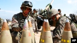 FILE - South Korean army soldiers arrange 155 mm howitzer shells during a military exercise in Goseong, South Korea, on April 4, 2016.