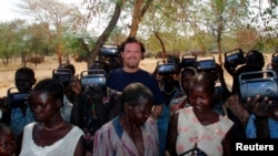 FILE - U.S. development worker John Granville, center, poses in this undated photo from the U.S. Agency for International Development, released Aug. 8, 2008. Granville and his driver were shot to death in Sudan in 2008.