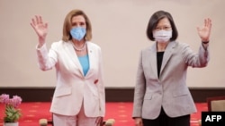 This handout taken and released by Taiwan's Presidential Office on August 3, 2022 shows US House Speaker Nancy Pelosi (L) waving beside Taiwan's President Tsai Ing-wen at the Presidential Office in Taipei. (Photo by Handout / Taiwan Presidential Office / AFP)