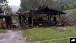 Debris is scattered around destroyed wooden structures near Aung Bar Lay Village, Hpakant township, Kachin state in Myanmar, Oct. 24, 2022.