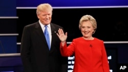 FILE- Republican presidential nominee Donald Trump and Democratic presidential nominee Hillary Clinton are introduced during the first presidential debate at Hofstra University in Hempstead, N.Y., Sept. 26, 2016. 