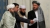 FILE - Members of Taliban delegation take their seats during the multilateral peace talks on Afghanistan in Moscow, Nov. 9, 2018.