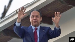Former dictator Jean-Claude 'Baby Doc' Duvalier waves to supporters from the balcony of a rented guest house where he is staying in Port-au-Prince, Haiti, (File)